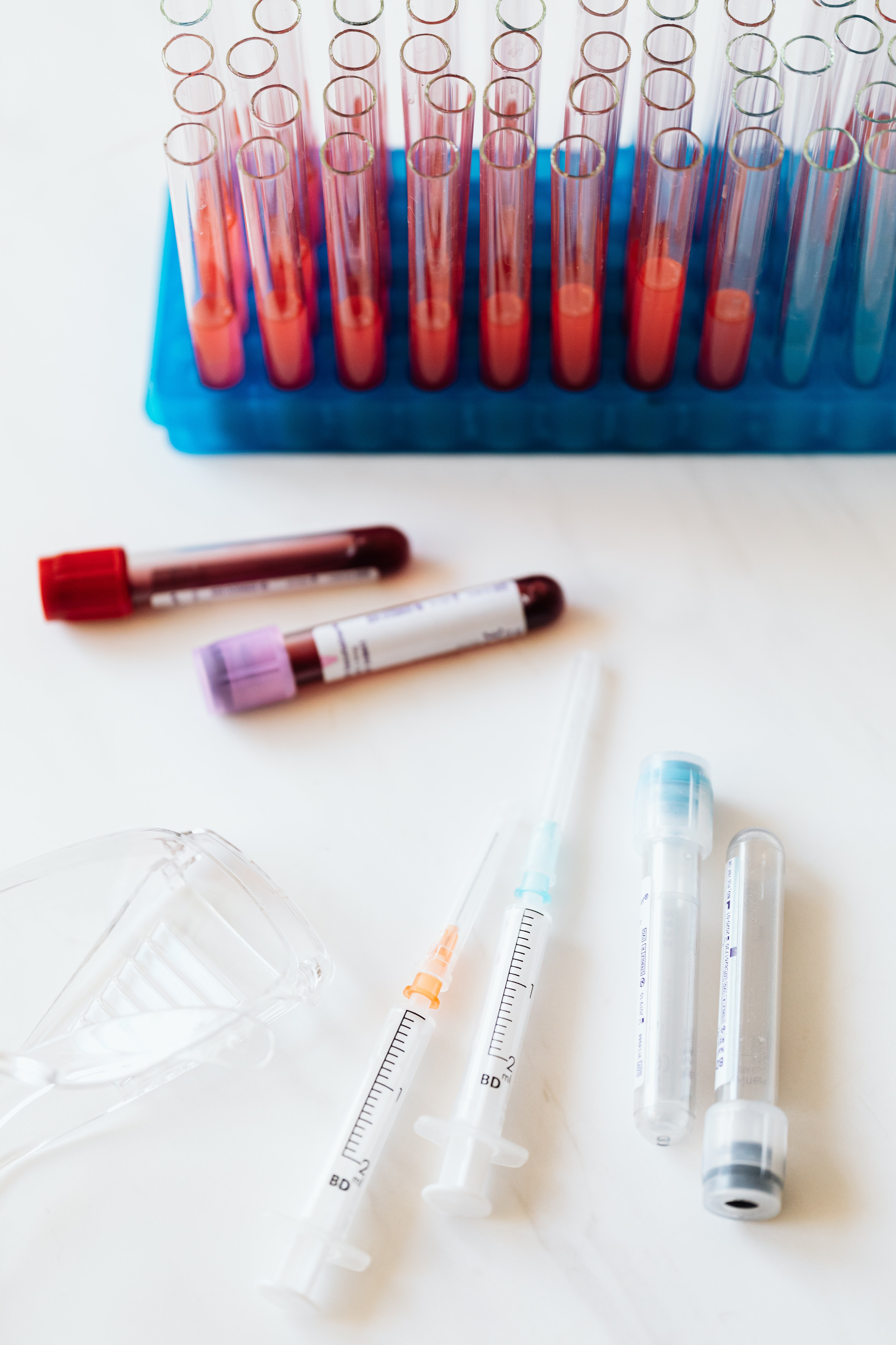 Syringes and test tubes on table in laboratory