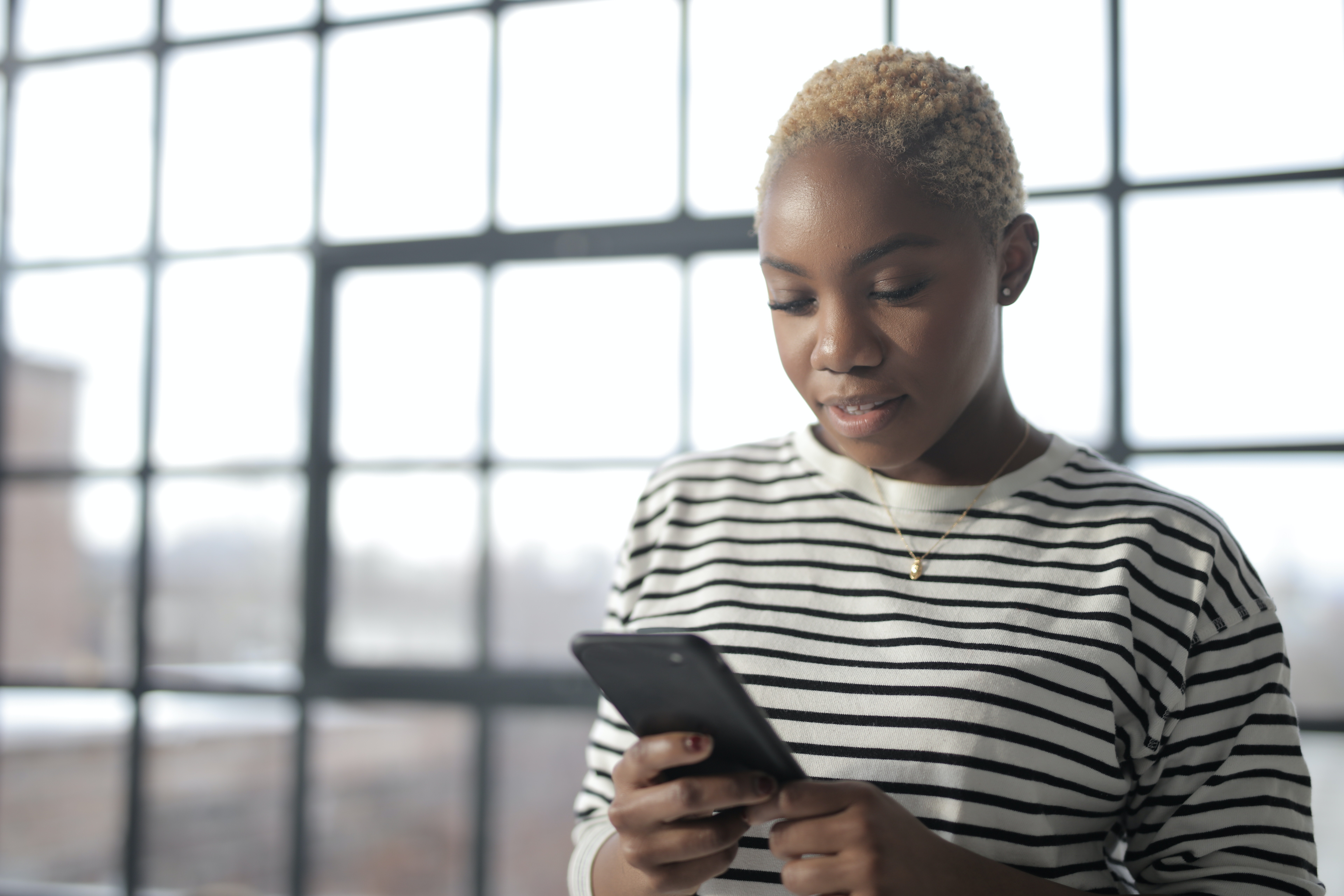 young lady holding her phone