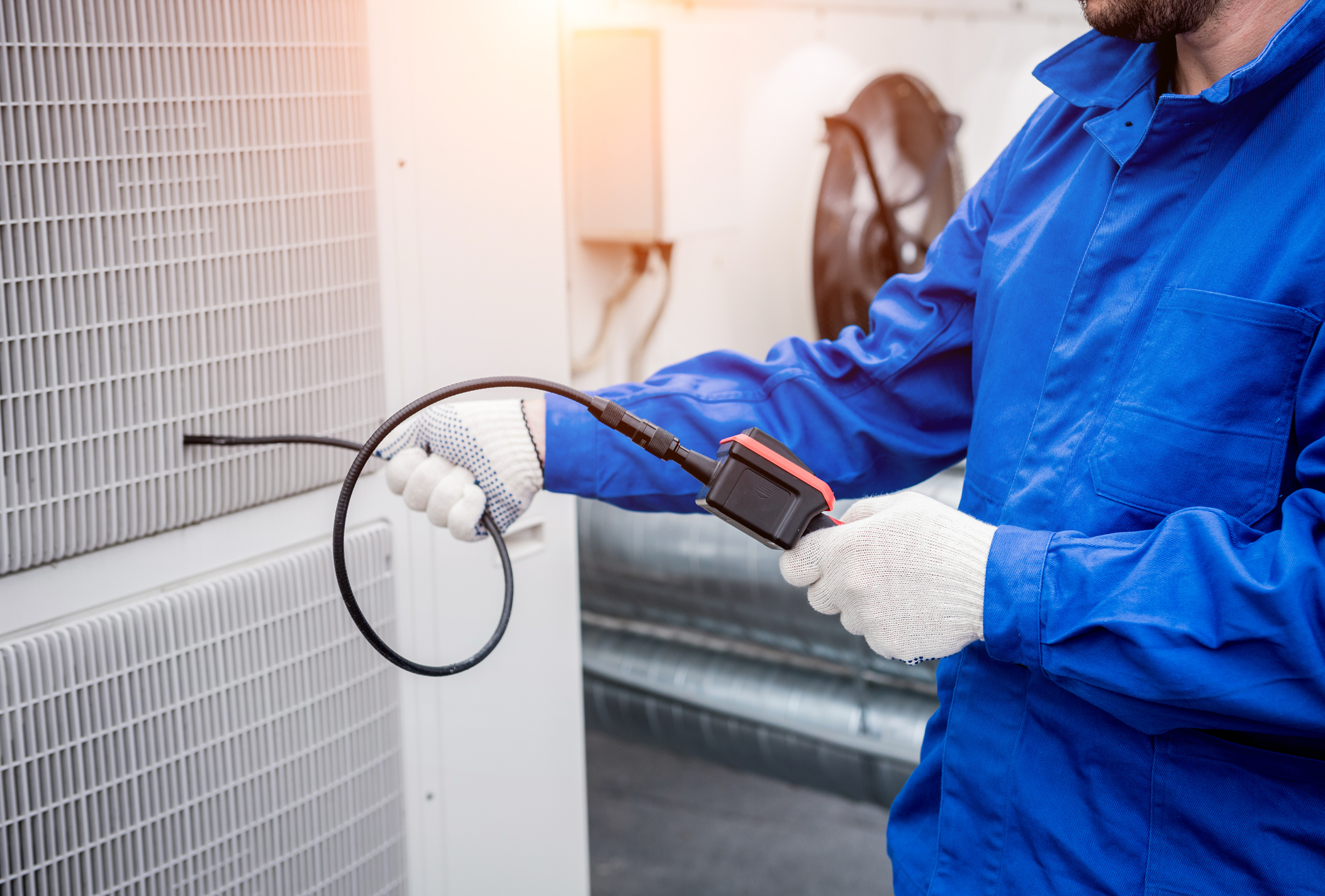 The technician uses a digital camera to check the clogging of the heat exchanger