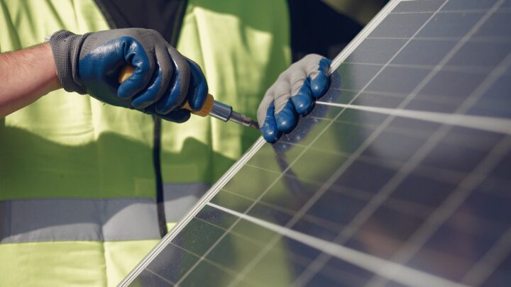 close-up of a working installing solar panels