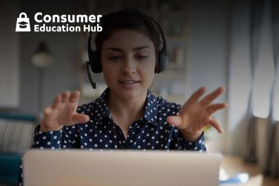 Lady with Headphones speaking in front of laptop