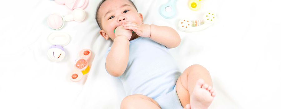 baby boy holding a bite toy