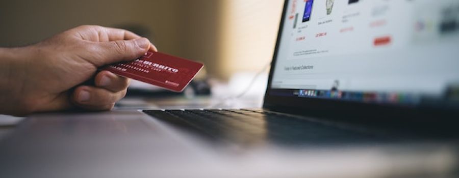 Person holding a credit card while buying online