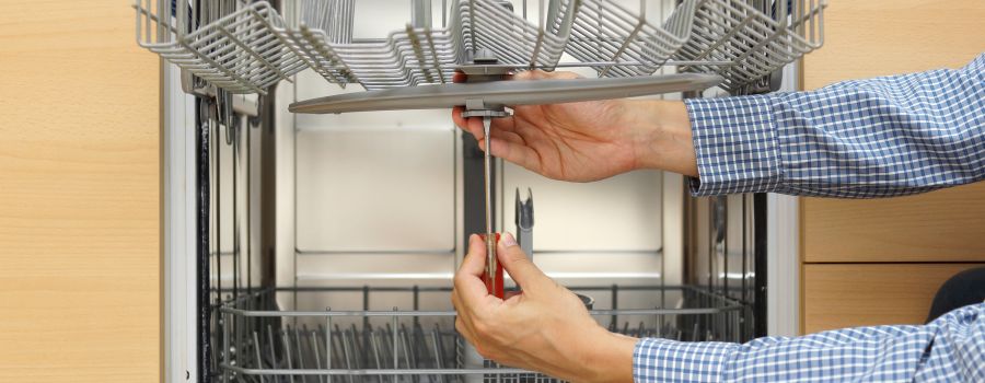 Techinician repairing a dishwasher