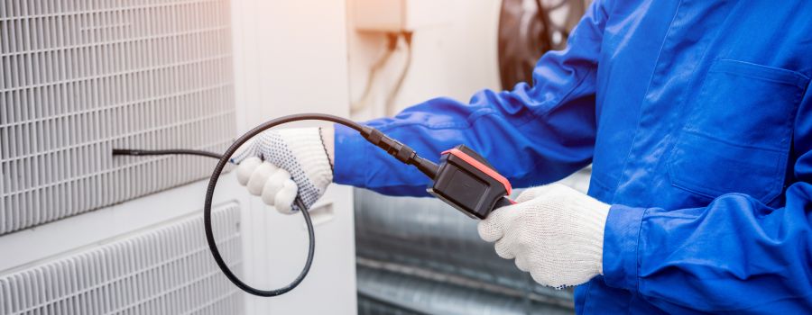 The technician uses a digital camera to check the clogging of the heat exchanger