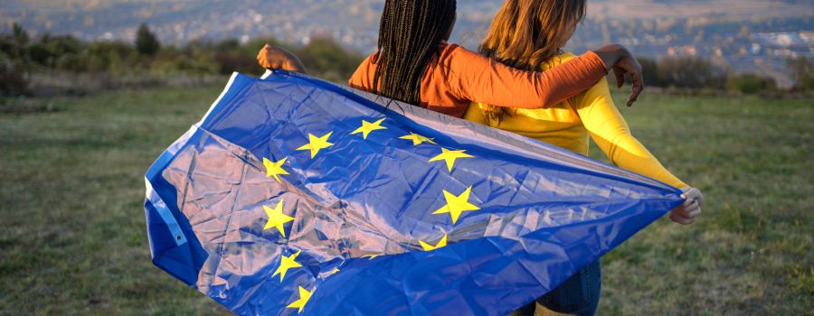 Young ladies holding the EU flag